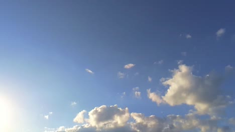 panning downward from blue sky with cumulus clouds to beautiful green agricultural field in germany