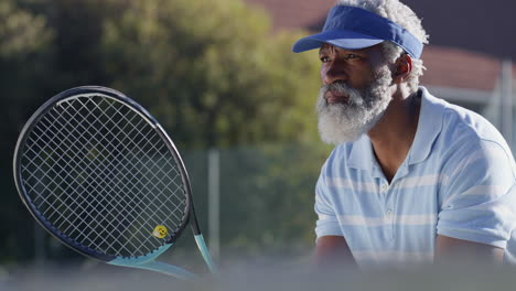 older man playing tennis