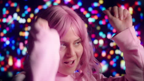 pink-haired party girl dancing with colorful lights in background