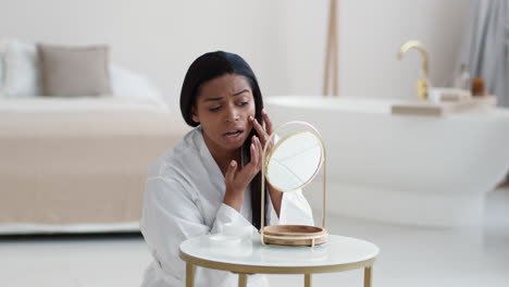 woman checking her skin in the bathroom