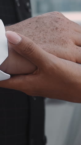 loving young couple of bride and groom joins hands during wedding extreme closeup slow motion. new family marriage celebration. love relationship