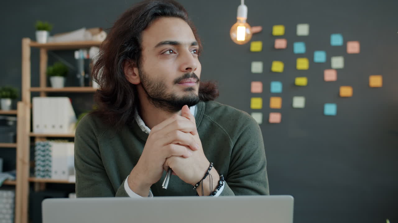 Young Man in Office Deep in Thought