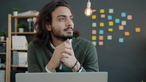 young man in office deep in thought
