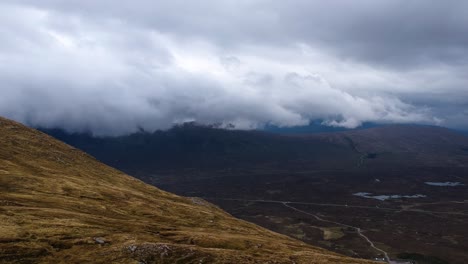 cinematic drone shot of scottish misty mountains with valley in background