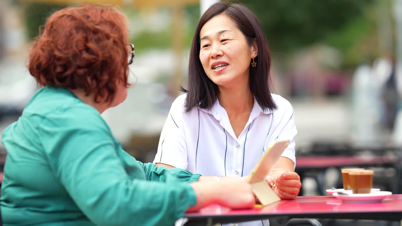 Two women having coffee at an outdoor cafe