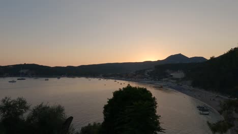 Panning-shot-over-Paralia-Valtos-with-boats-docked-during-sunset