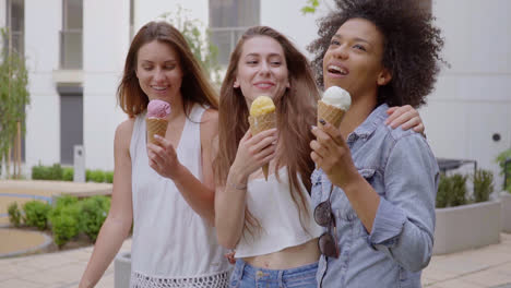 happy women walking and eating ice cream