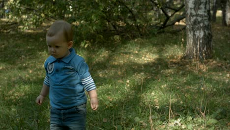 little boy with pick up ball and throw