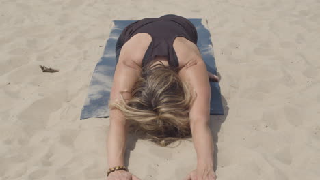 beautiful woman exercising yoga doing sleeping swan