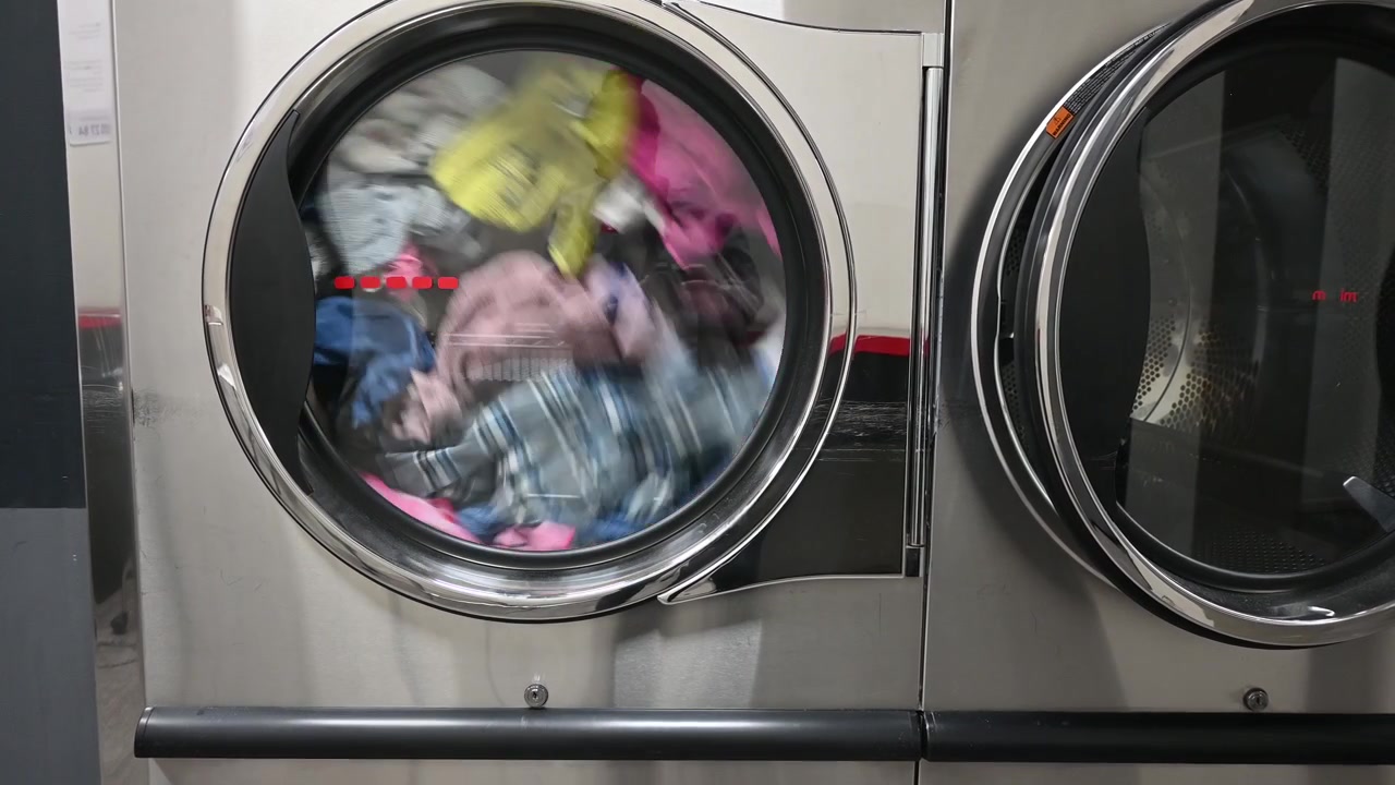 Industrial washing machine operating in laundromat