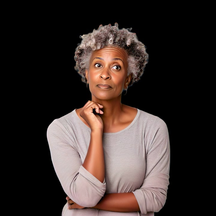 Thoughtful Mature Woman Looking Up Against Black Background