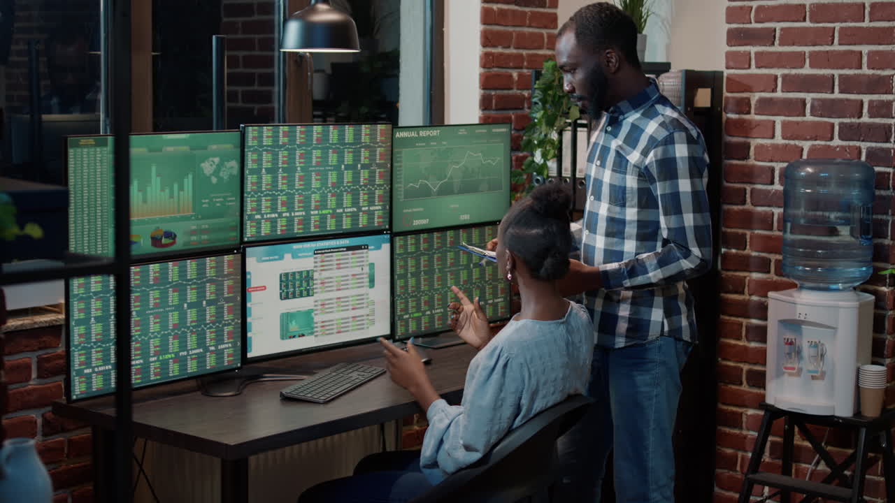 Business team working with stock market statistics on multi monitors