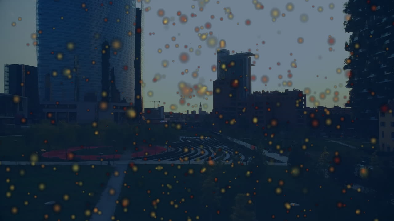 Cityscape with colorful animation particles floating over urban skyline at night