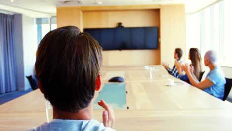 creative business team applauding while attending a video call