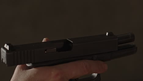 wide view of glock 17 handgun chambering a live round