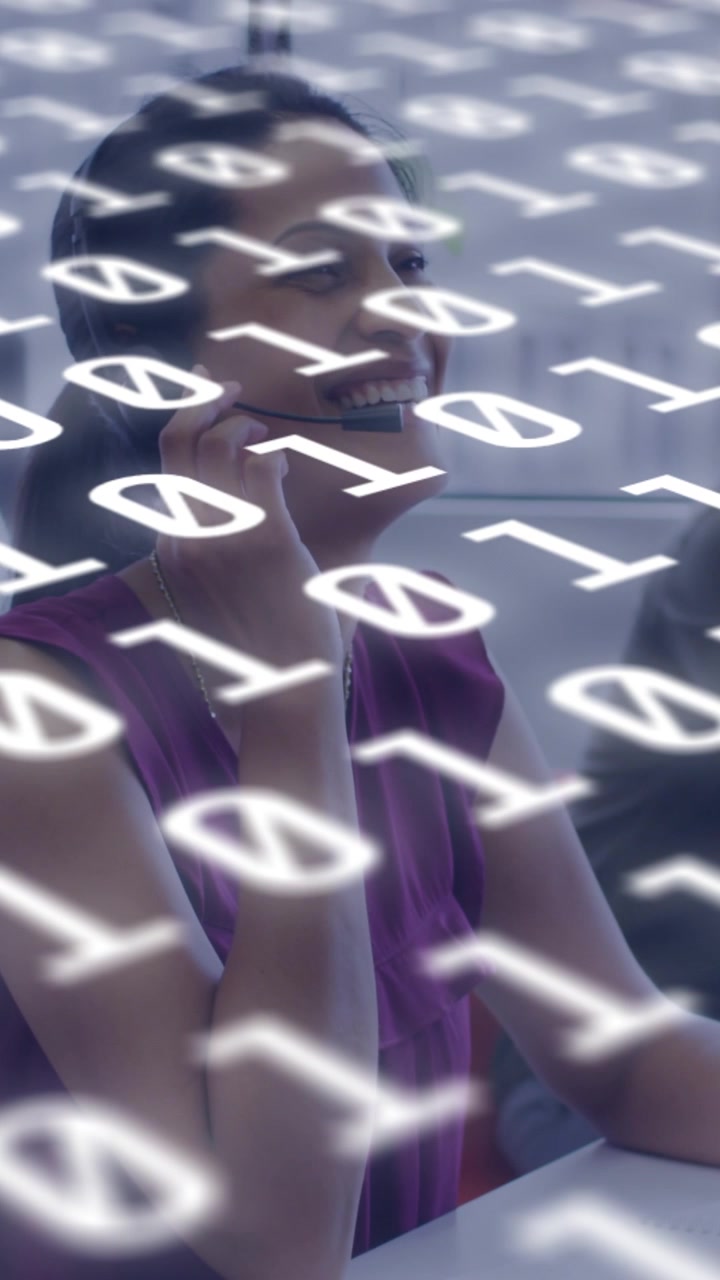 Vertical video: Woman raising phone, making call and smiling as binary digits overlay tech for work