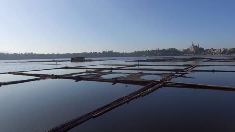 bamboo hut structure for local aquaculture provide domestic food needs of small rural farming community in sampaloc lake, laguna. drone, aerial shot