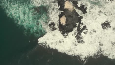 Waves-hitting-rocky-formations-from-above,-Aerial-Shot,-Pichilemu,-Chile