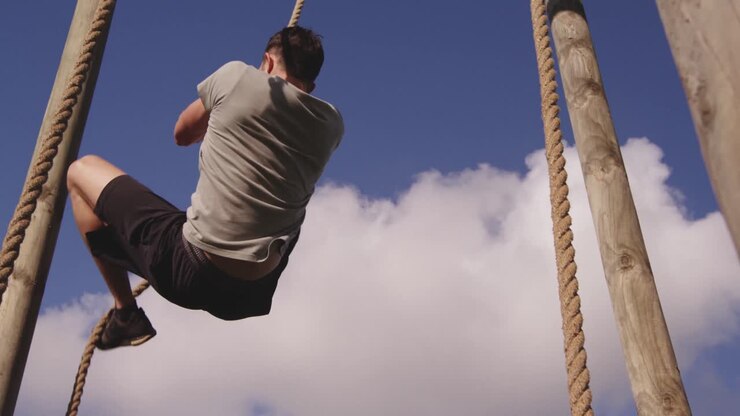 Young man training at an outdoor gym bootcamp