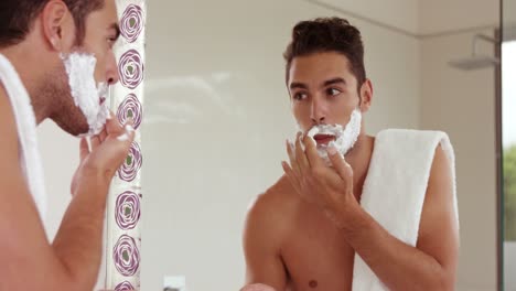 handsome man putting shaving foam on face