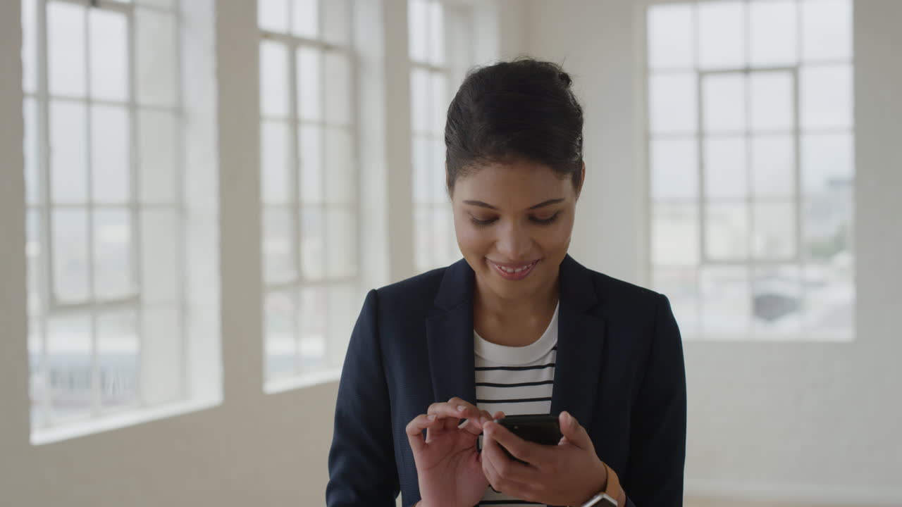 portrait of young mixed race woman using smartphone texting browsing on mobile phone messages networking female business entrepreneur enjoying digital communications