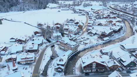 snowy kandersteg town in switzerland with flowing river in winter