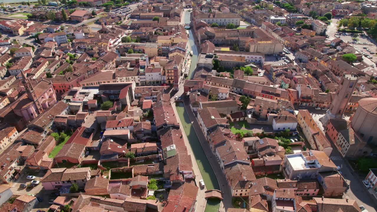 Comacchio, Italy, drone tilt-down view of urban infrastructure, city's canal, little Italian city, sunny weather