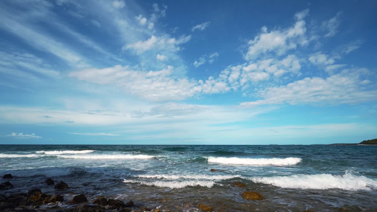 Time lapse of shifting white clouds over calm Adriatic waters along Croatia’s coast