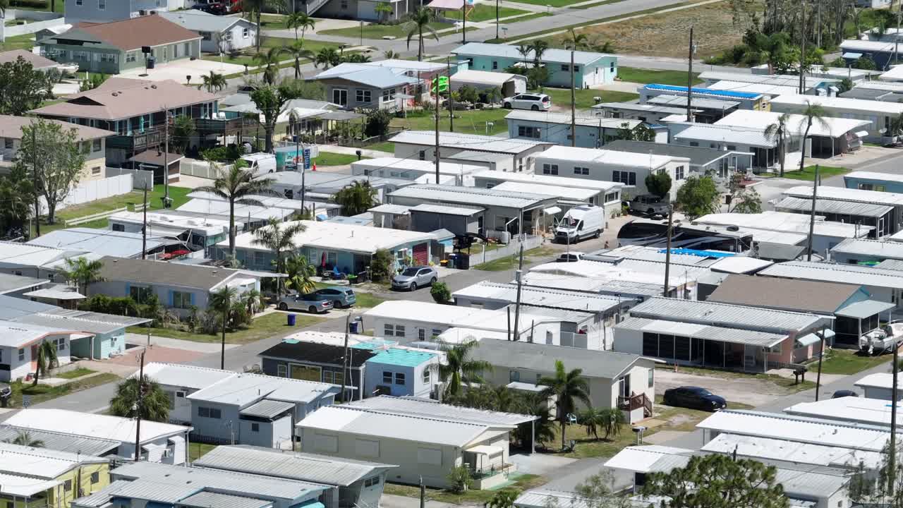 Parking cars on street of dense populated mobile trailer home park in Cortez, Florida. Aerial zoom shot. Housing area of cheap suburb neighborhood in America.