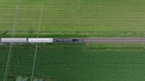 aerial view of a train passing through agricultural fields