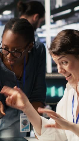 vertical video data center technicians adjusting blade server hardware powering ai