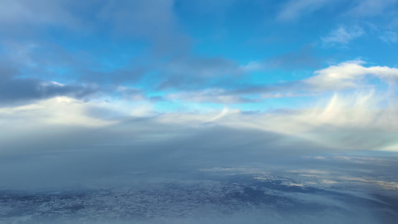Pilot’s Eye POV Flying Through Snow Clouds, with Snowfall Vivible in the Distance. Cockpit View Approaching to Munich Airport (MUC)
