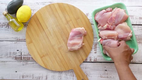 raw chicken thighs with lemon and olive oil for cooking