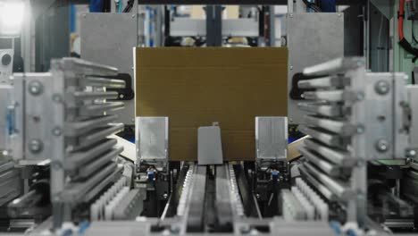 mechanized assembly line as goods are boxed with innovative automated machinery