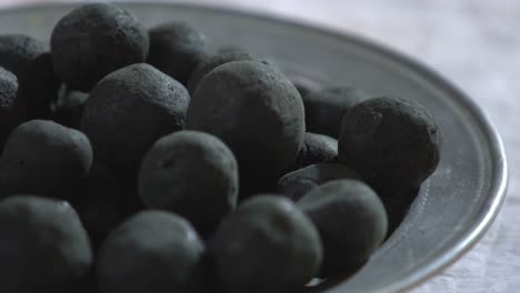 closeup shot of dried madder dye balls, used for ajrak printing and dyeing organic textiles