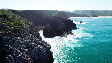 waves crashing against the rocks and cliffs. - aerial shot