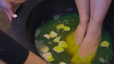 Refreshing-foot-bath-in-a-tub-with-rose-petals-at-the-beauty-salon