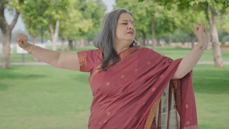 Tired-and-Lazy-Indian-old-woman-yawning-in-park