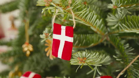 close-up of a danish flag ornament on a festive christmas tree