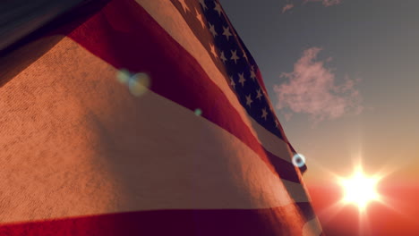 sun behind the waving american flag at afternoon of memorial day