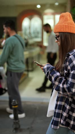 young woman texting in a city setting