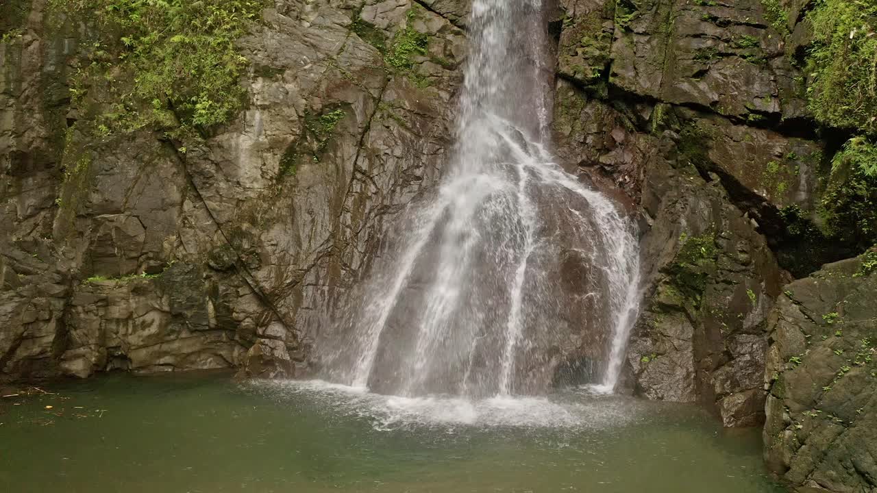 Tranquil Waterfall Cascading Through Lumondo's Rainforest in the Philippines