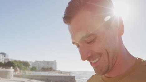 young man on a beach smiling