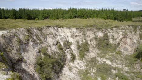 a wide panning shot of a crater at craters of the moon in taupo, nz