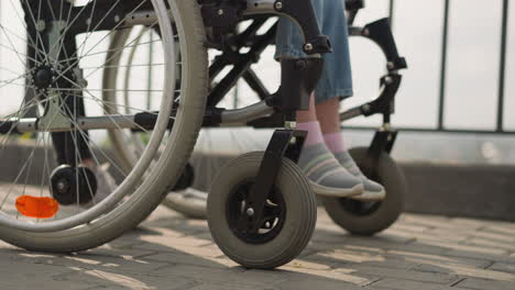 Woman-pushes-medical-equipment-with-schoolgirl-after-surgery