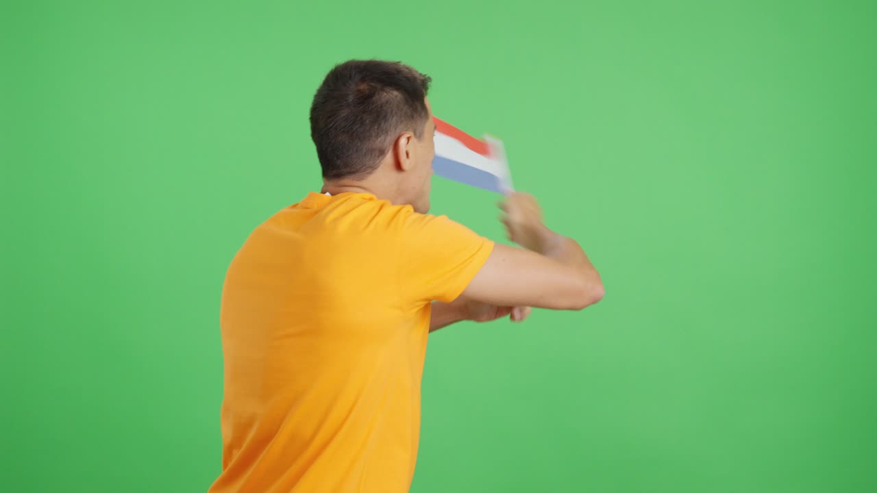 Rear view of a man waving a dutch pennant