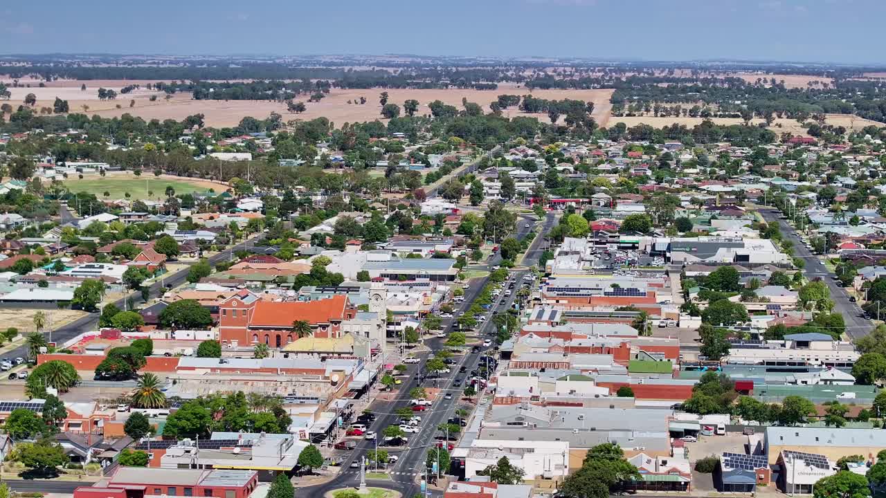 Reveal of cars driving and buildings in the main street of Yarrawonga on a sunny day