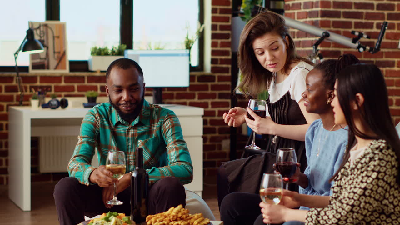 Diverse group of people socializing at home, enjoying appetizers