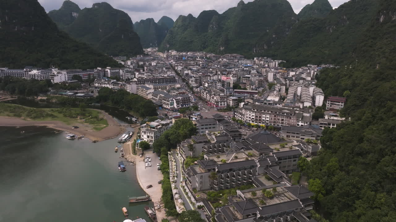 Aerial view approaching the Yangshuozhen town, cloudy day in Yangshou, China