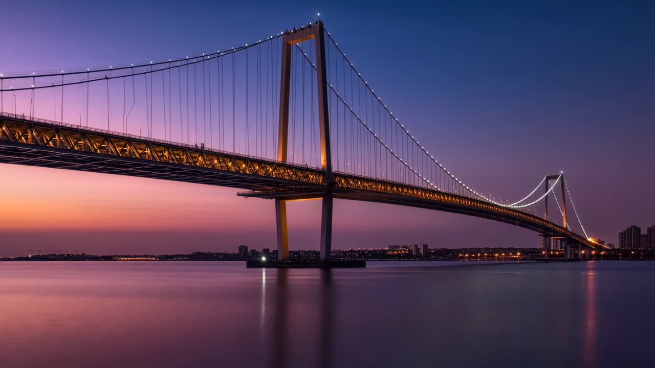Suspension Bridge at Dusk with City Lights